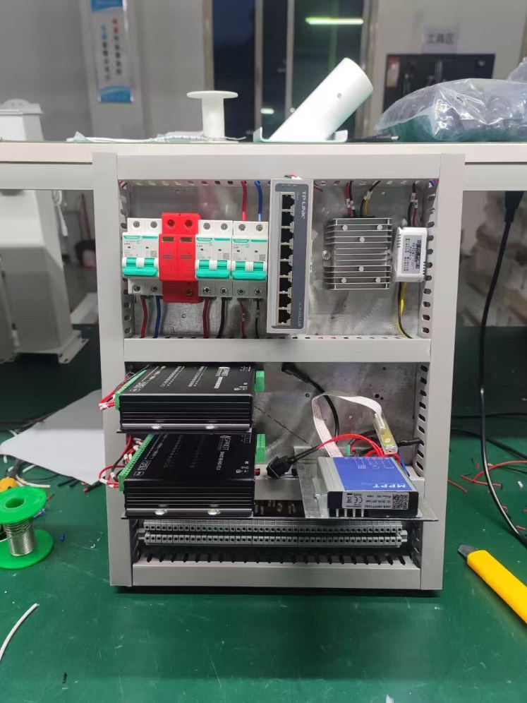 Inside view of a solar-powered CCTV control cabinet with MPPT and power modules for highway LED signage and surveillance
