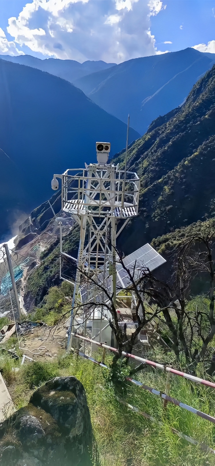 Solar-powered CCTV tower with solar panels deployed in forested mountain zone