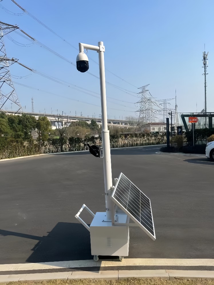 Solar-powered CCTV trailer monitoring highway traffic zones with remote surveillance capabilities