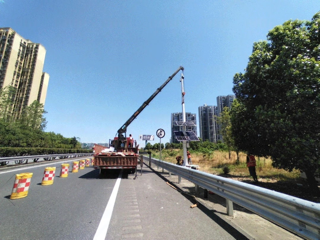 Solar-powered CCTV system installed on a roadside pole with dual solar panels, ensuring off-grid traffic safety and highway monitoring