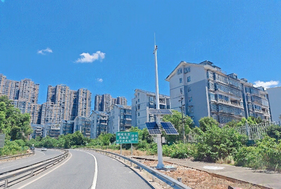 Pole-mounted solar CCTV system with dual solar panels installed along an urban highway, designed for road surveillance and traffic safety monitoring in China