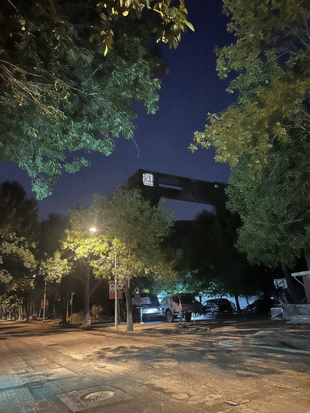 Solar CCTV system illuminating rooftop LED signage at night with off-grid solar power kits for advertising lighting, real-time surveillance, and energy savings by Shenzhen Kongfar Technology in Tianjin