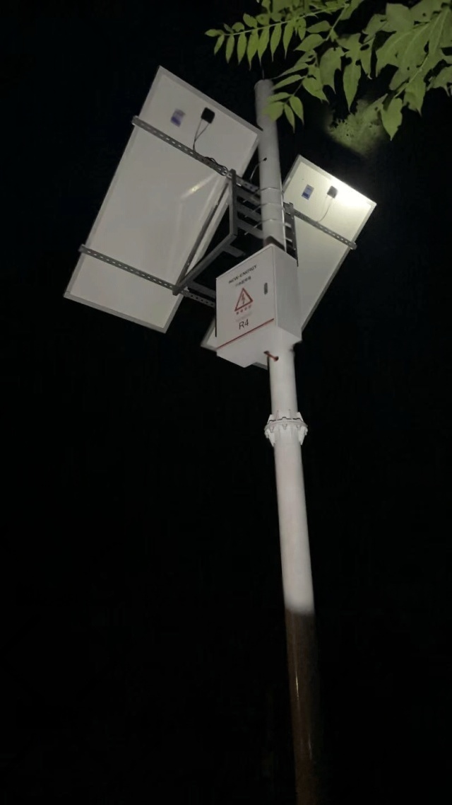 Nighttime close-up of Shenzhen Kongfar Technology’s solar-powered monitoring equipment operating along Tonghua River, highlighting reliable off-grid power and continuous flood-control data transmission under low-light conditions