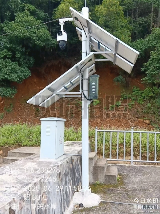 Solar power kit for water monitoring deployed at a reservoir site in Fujian Longyan, featuring photovoltaic panels, protective housings, and monitoring equipment operating in a humid vegetation-dense environment to support continuous hydrology sensing and reservoir safety surveillance by Shenzhen Kongfar Technology