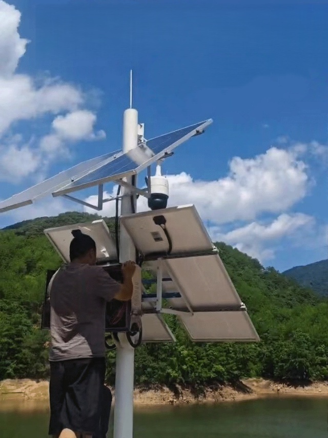 Solar power kit for water monitoring installed along a riverbank in Fujian Longyan, providing continuous off-grid energy to water-level sensors, surveillance cameras, and environmental monitoring devices operating in a humid mountain terrain to support smart water-resource management by Shenzhen Kongfar Technology