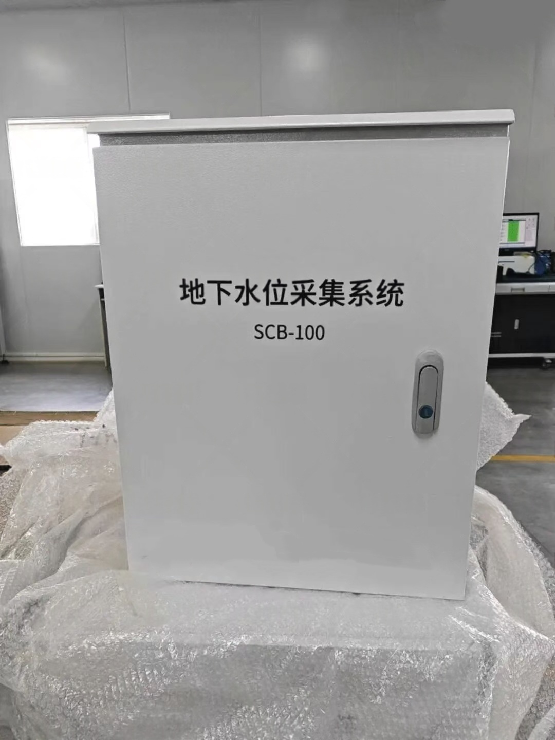 The SCB-100 groundwater monitoring control enclosure used with solar power kits, designed with weather-resistant materials to house sensors, power electronics, and communication modules for long-term hydrology data acquisition