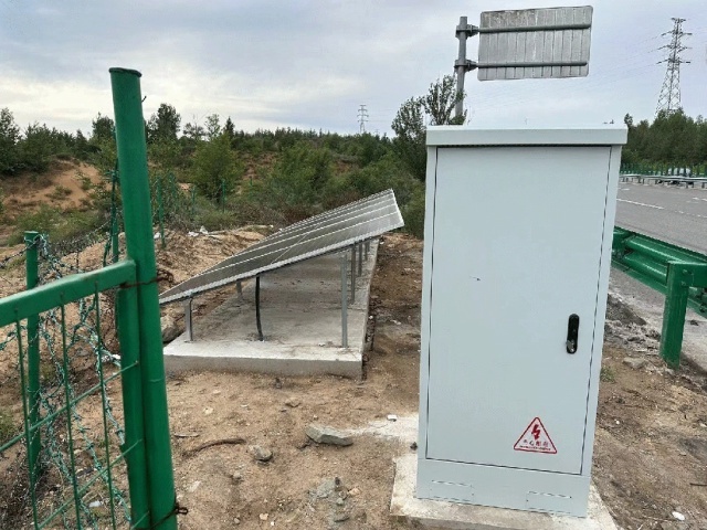 Complete off-grid solar power system installed on a highway slope with sealed equipment cabinet powering CCTV and deflection sensors for continuous safety monitoring in Yulin, Shanxi, China