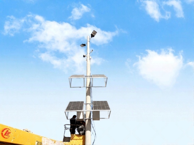 A pole-mounted off-grid solar power system showing the structural layout of solar panels and supporting components used to supply continuous energy for sand mining surveillance applications