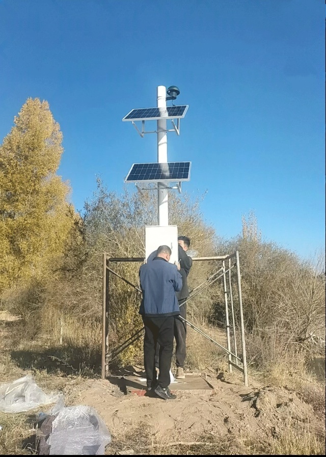 Solar-powered river security monitoring installation using an off-grid solar power system for hydrological surveillance in wind-sand and low-temperature riverbank environments in Zhangye, Gansu, China