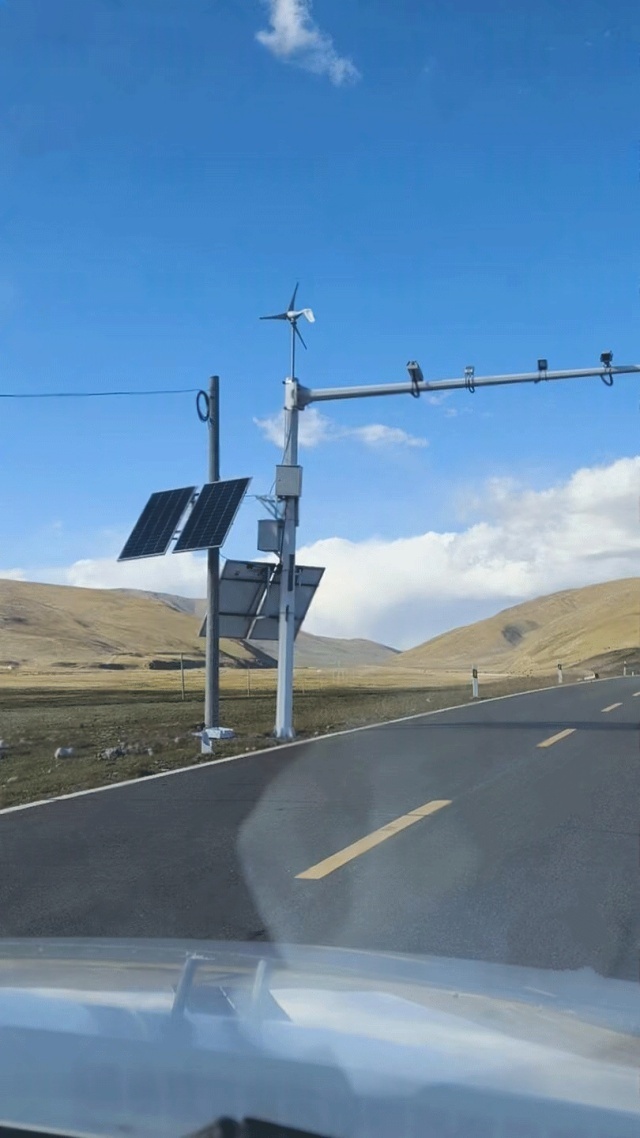 An off-grid wind–solar hybrid power system installed along a mountain road to support continuous security surveillance under high rainfall and complex terrain conditions in Ya'an, Sichuan, China