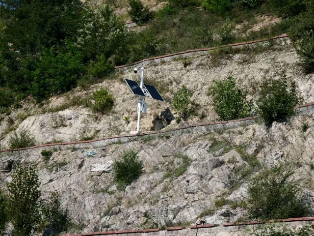 Off-grid solar CCTV monitoring system deployed along a mountainous road in Shijiazhuang, Hebei, illustrating terrain exposure, installation spacing, and roadside surveillance layout