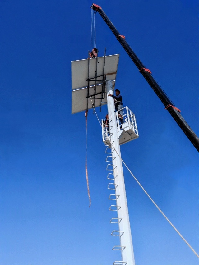 Off-grid solar power system pole installation for desert road surveillance in Jiuquan, Gansu, showing high-altitude deployment under wind-exposed conditions