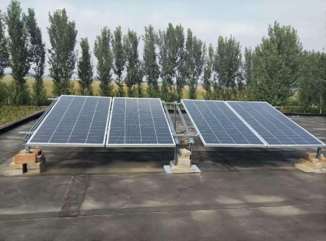 Planar-layout photovoltaic panels mounted near fish ponds in Zhangjiakou, designed to reduce wind-sand accumulation and maintain stable daily solar generation for off-grid pump power supply
