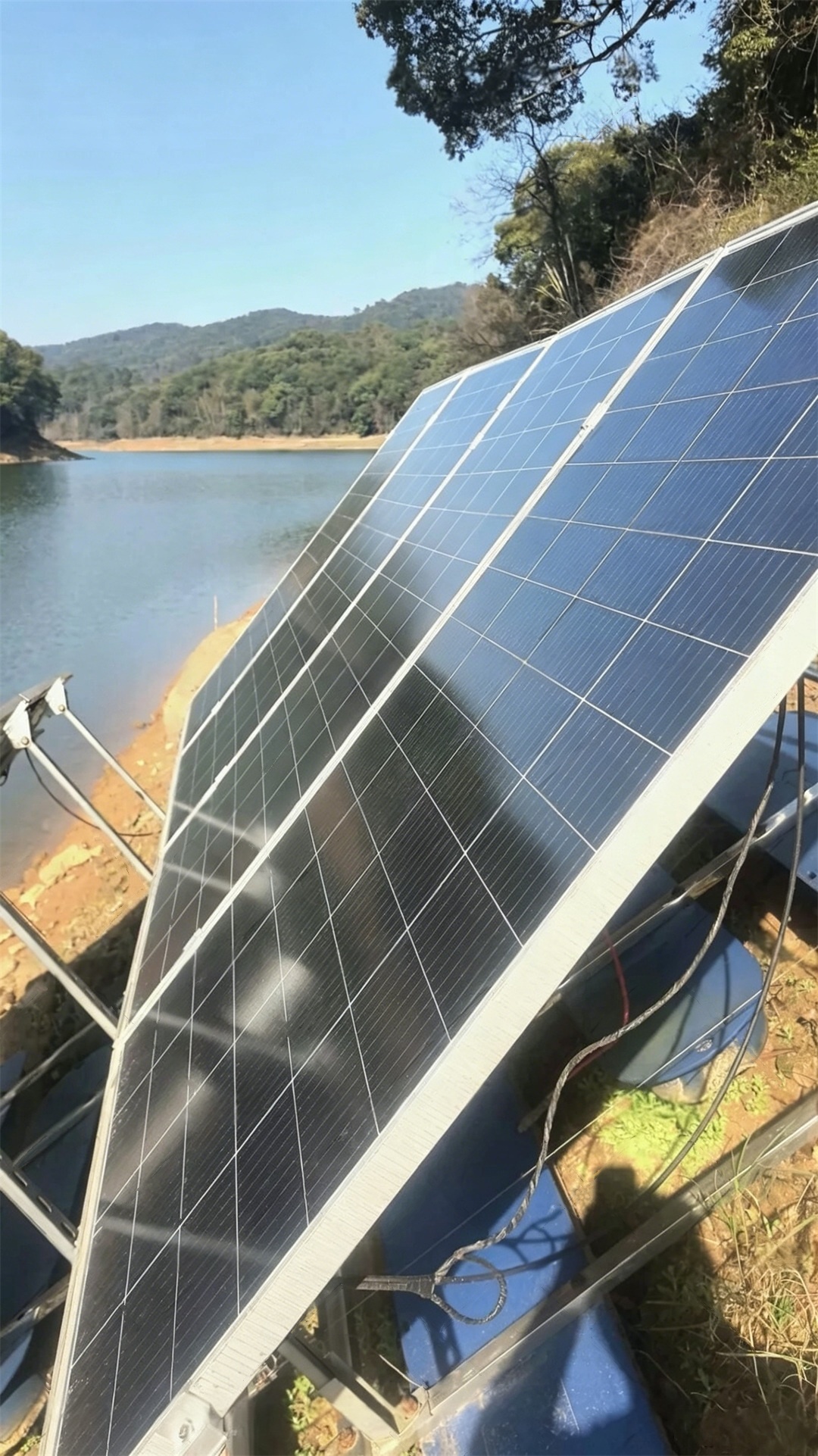 reservoir-side solar panel array for forest fire monitoring power supply in Yichun Jiangxi China demonstrates that photovoltaic recovery architecture restores battery reserves for continuous fire surveillance under humid mountain, rainfall, fog, and grid-absent deployment conditions